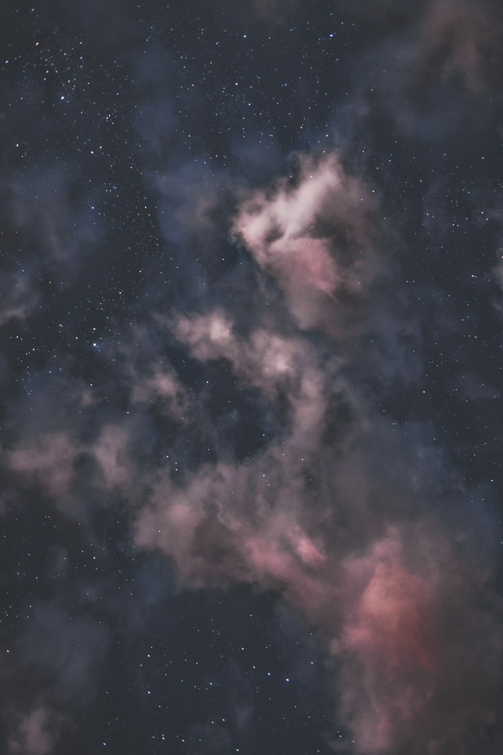 the night sky is filled with stars and clouds