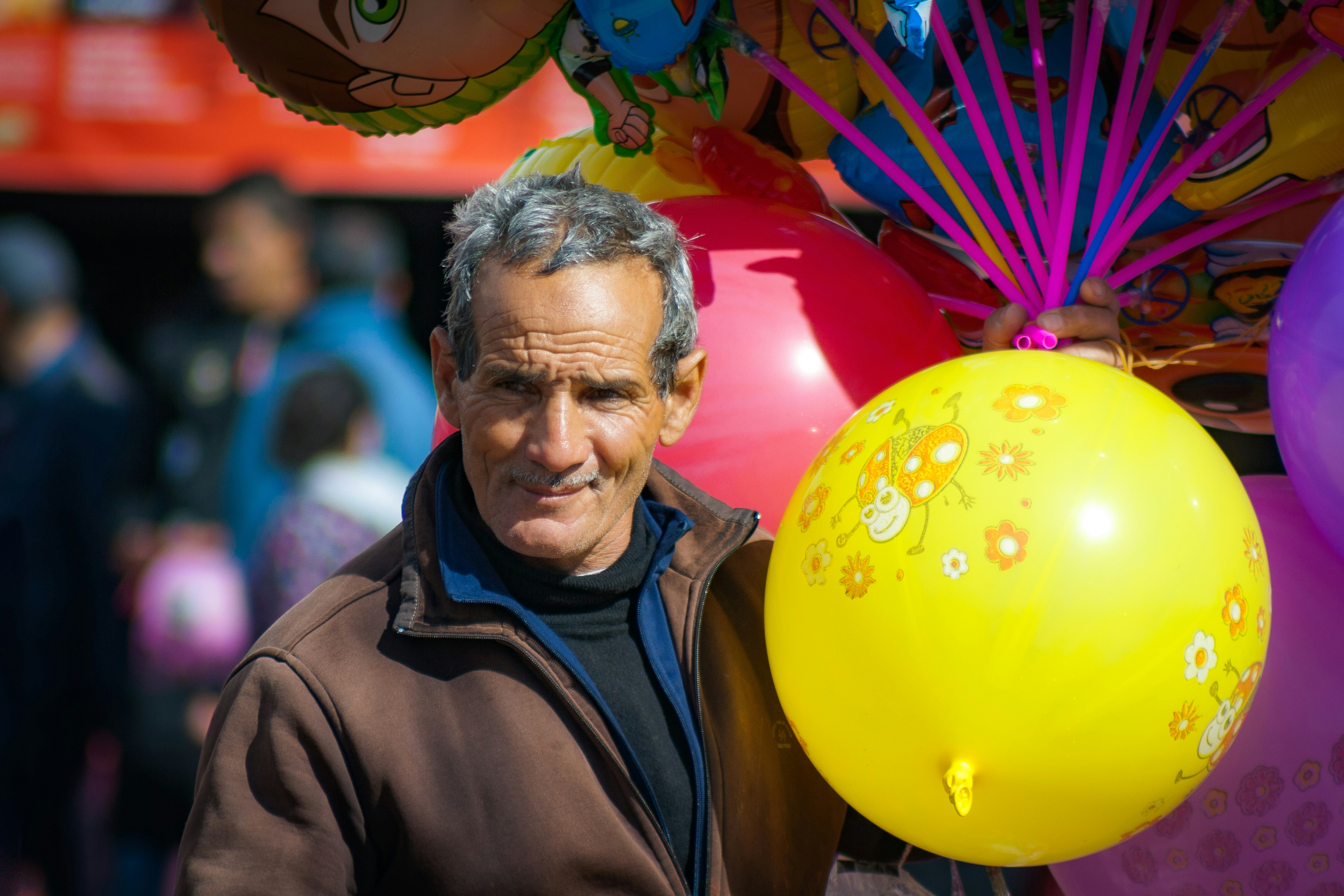 Man in brown jacket smiling
