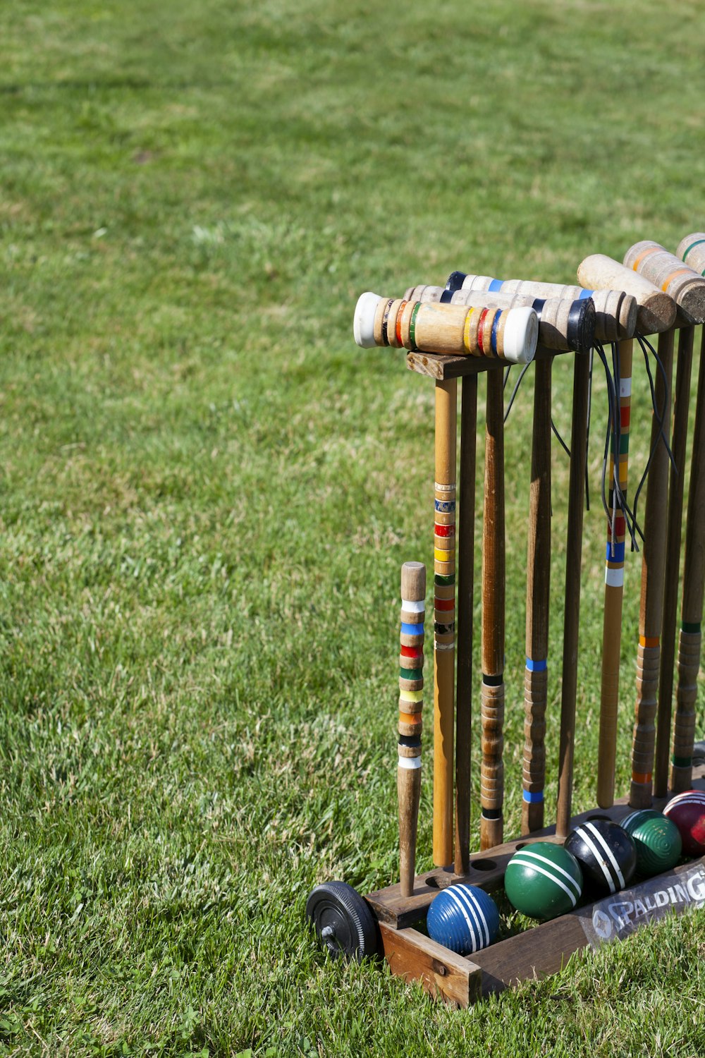 orange and blue wooden sticks on green grass field during daytime