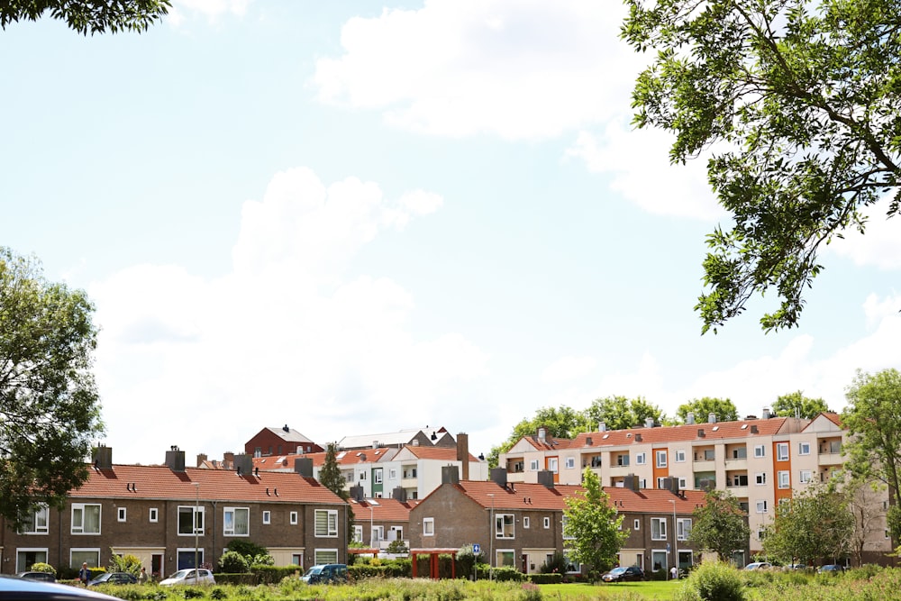 brown and white concrete houses under white sky during daytime