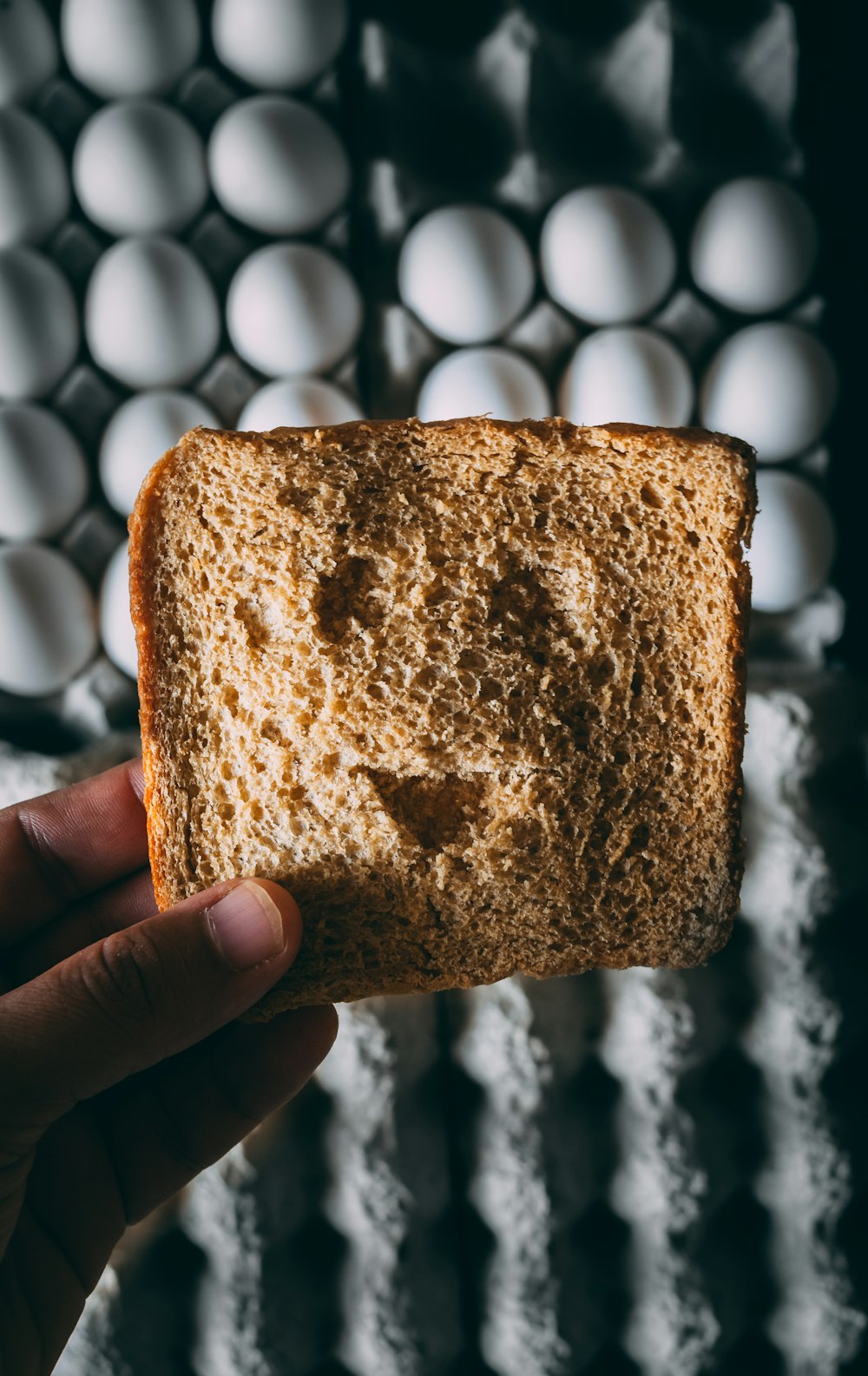 person holding brown bread with brown powder