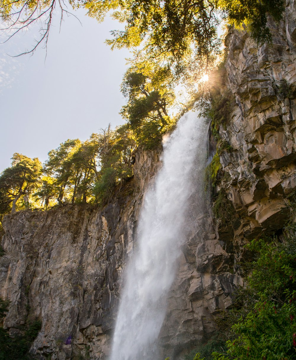 waterfalls on rocky mountain during daytime