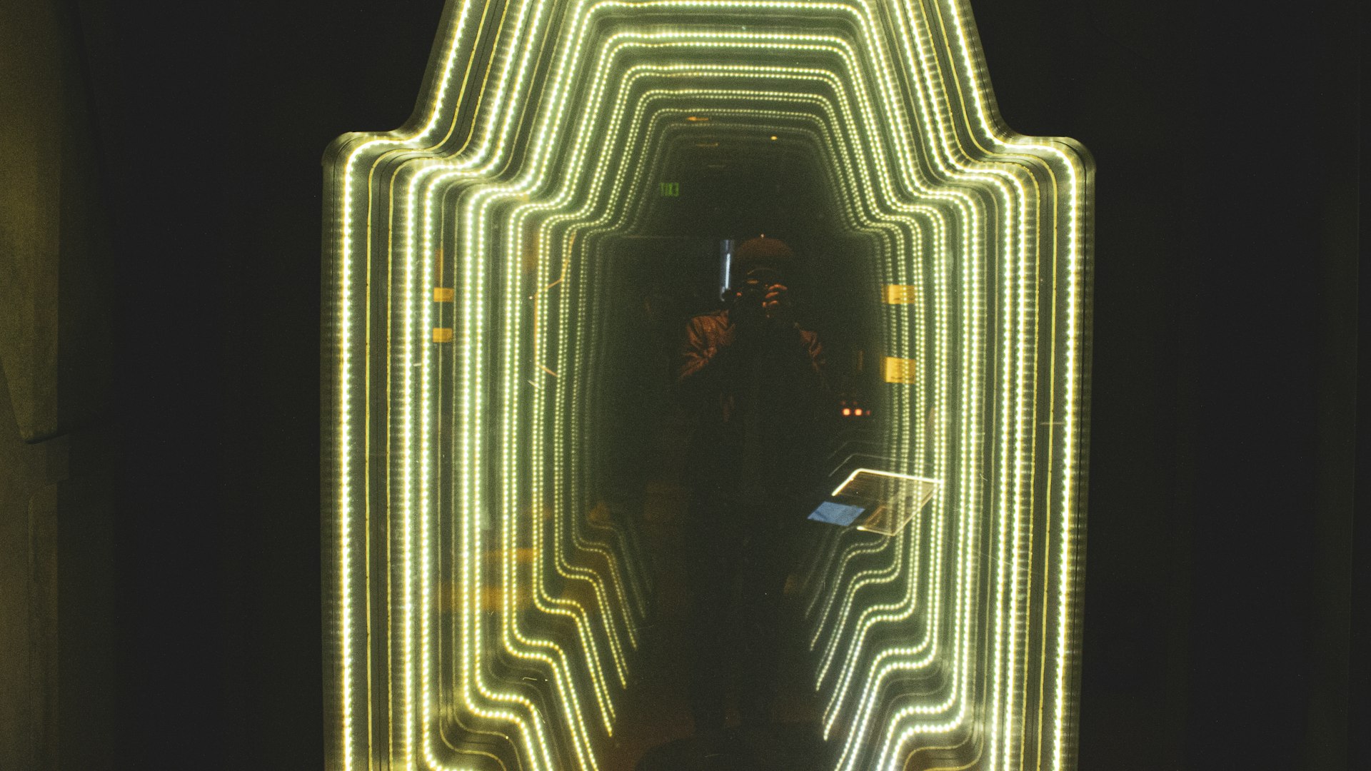 man in black jacket standing on tunnel