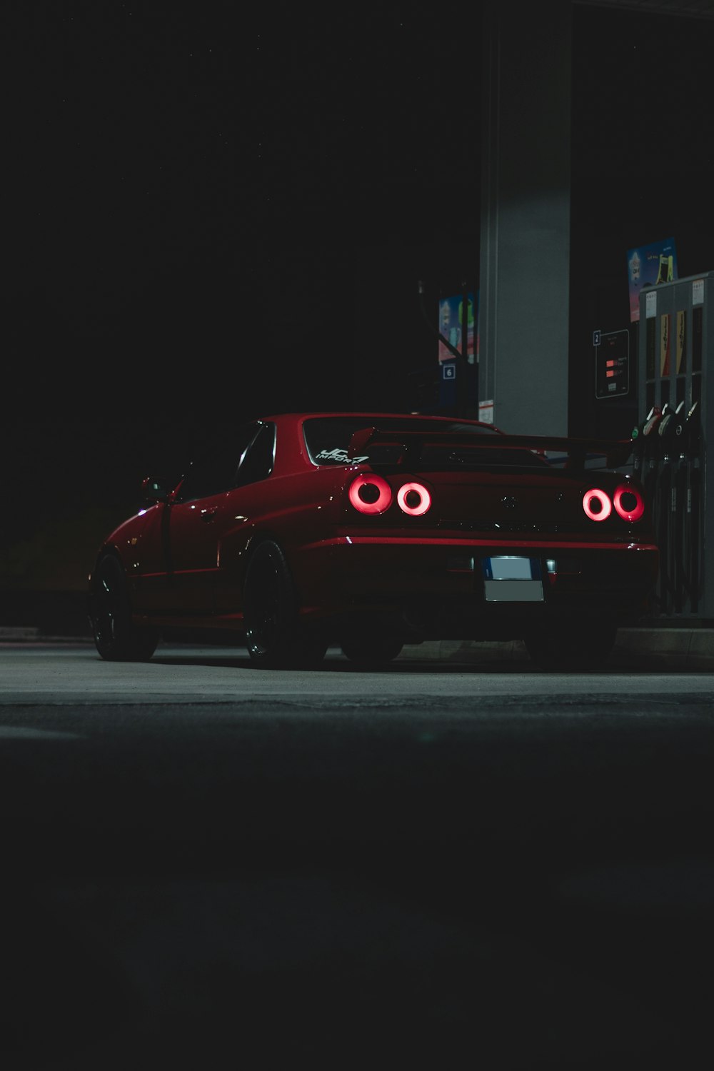 red porsche 911 parked on road during nighttime