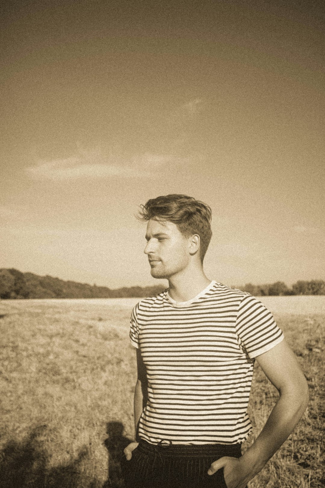 grayscale photo of man in striped shirt