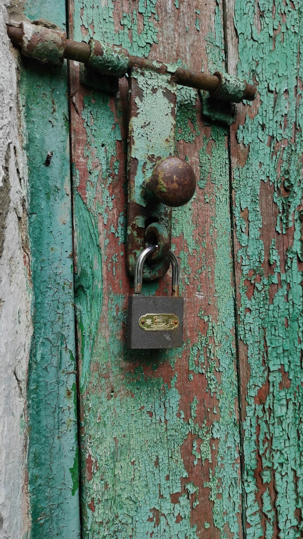 brass padlock on blue wooden door