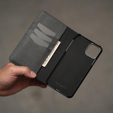 Close-up of a hand holding a phone with sportyplug24 wallet open displaying rewards.