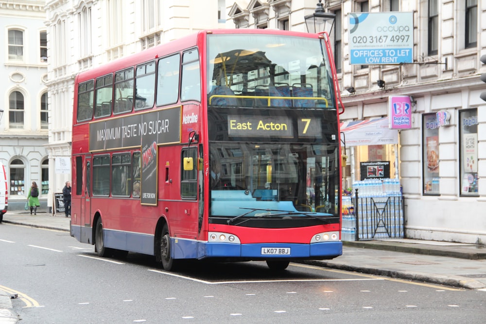 red and blue bus on road during daytime