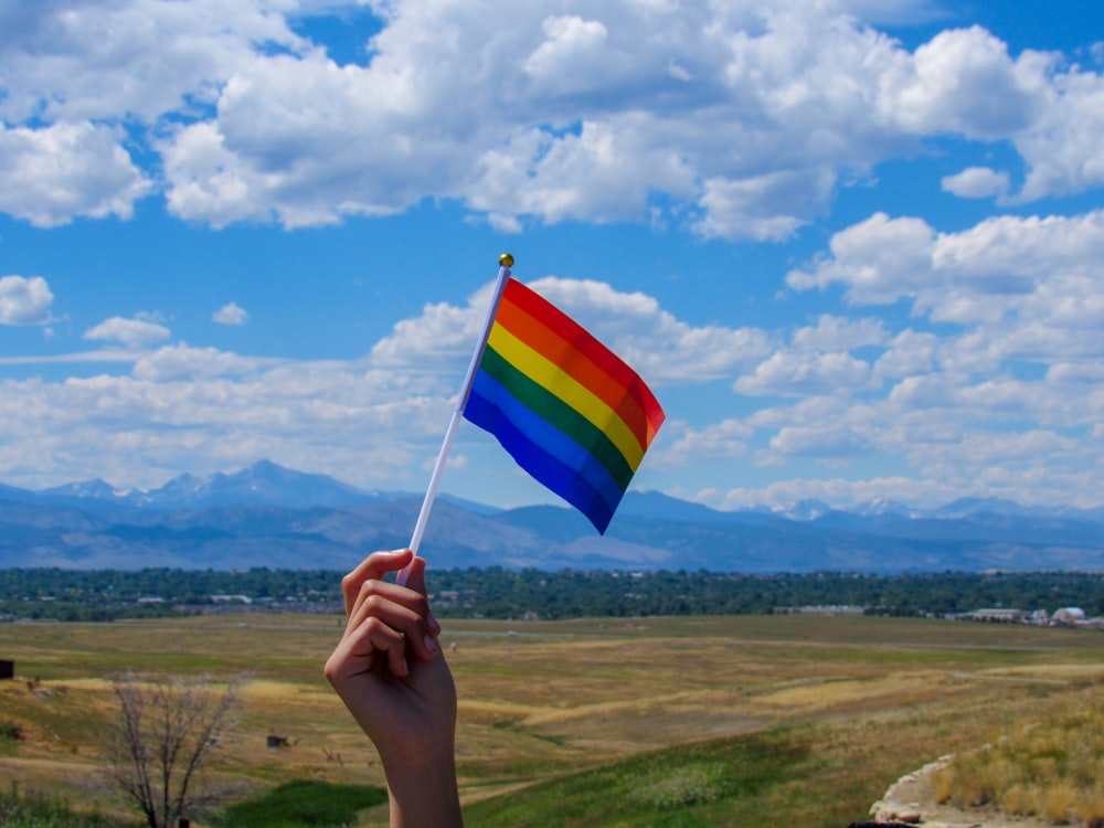 person holding blue white and red striped flag