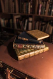 brown hardbound book on brown wooden table