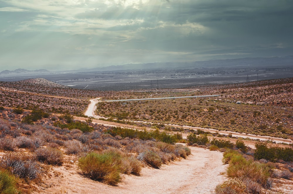 a dirt road in the middle of a desert