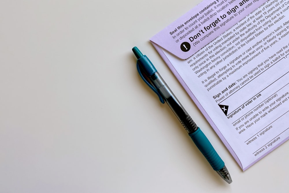 a pen sitting on top of a piece of paper