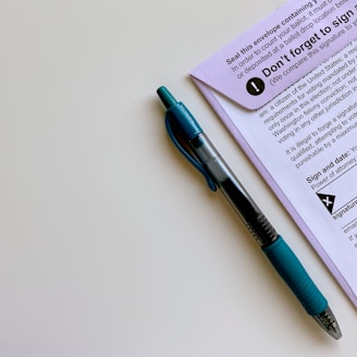 a pen sitting on top of a piece of paper