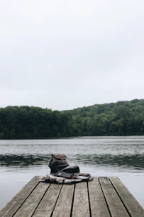 person riding on brown boat on lake during daytime