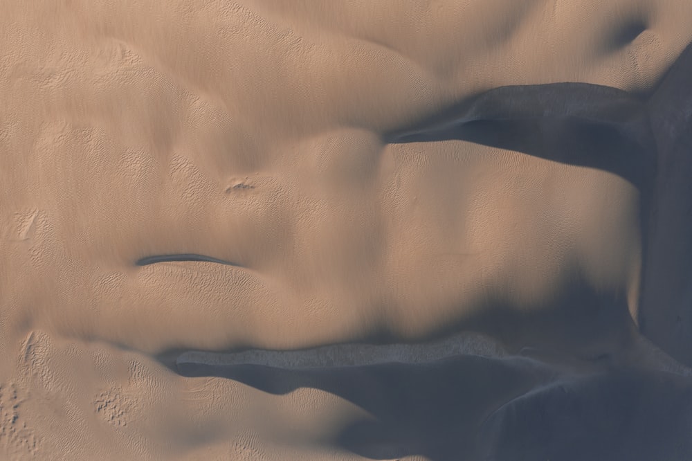 an aerial view of a desert with sand dunes