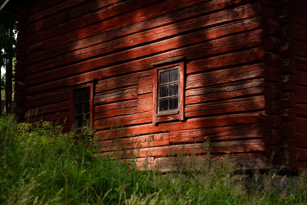 brown wooden house with green grass field