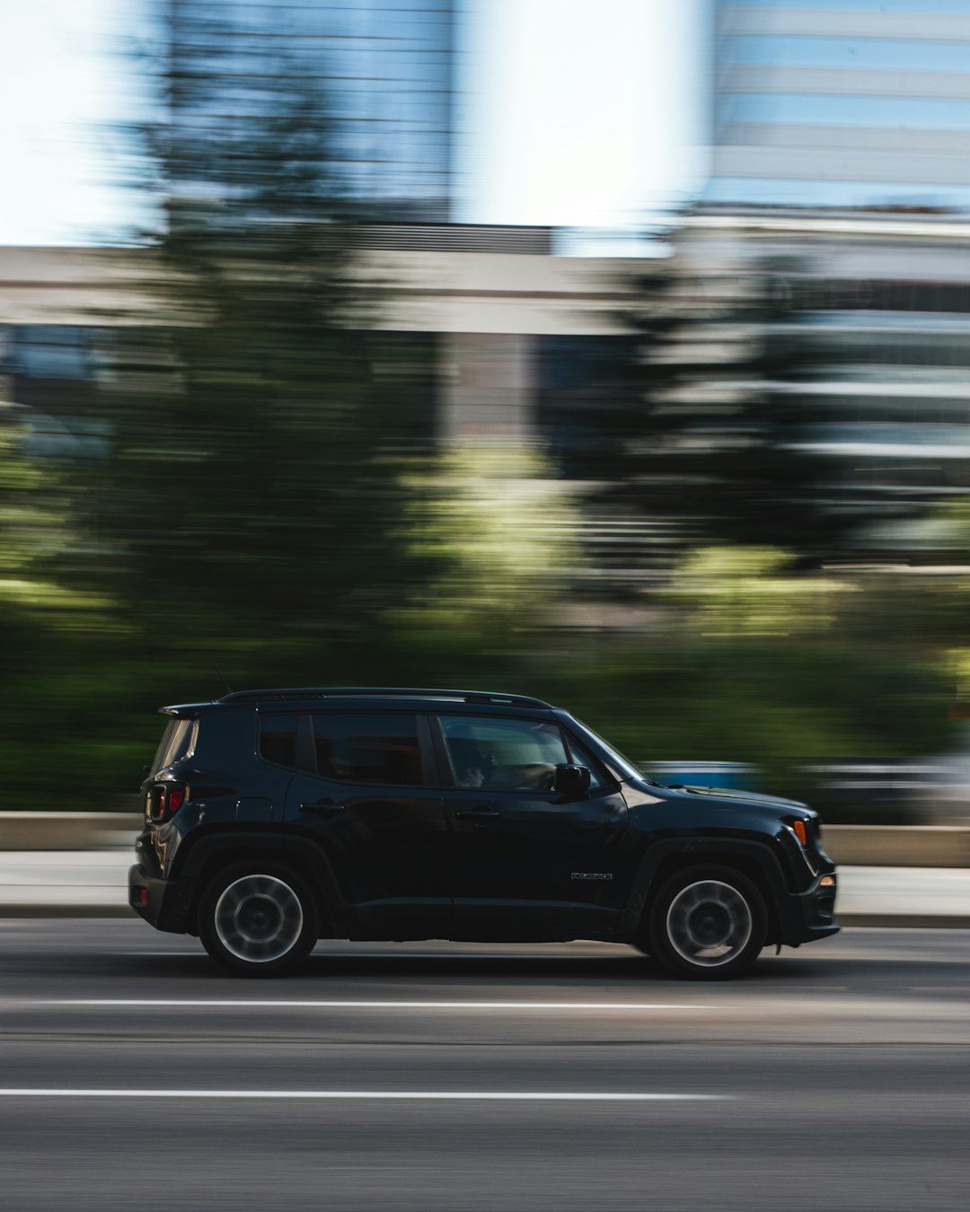 black suv on road during daytime