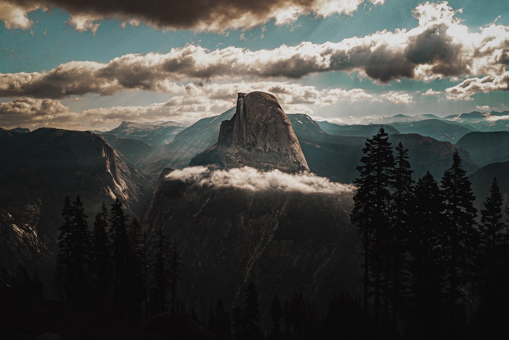 snow covered mountain under cloudy sky during daytime