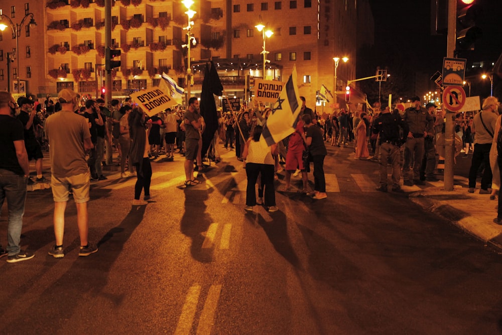 people walking on street during night time