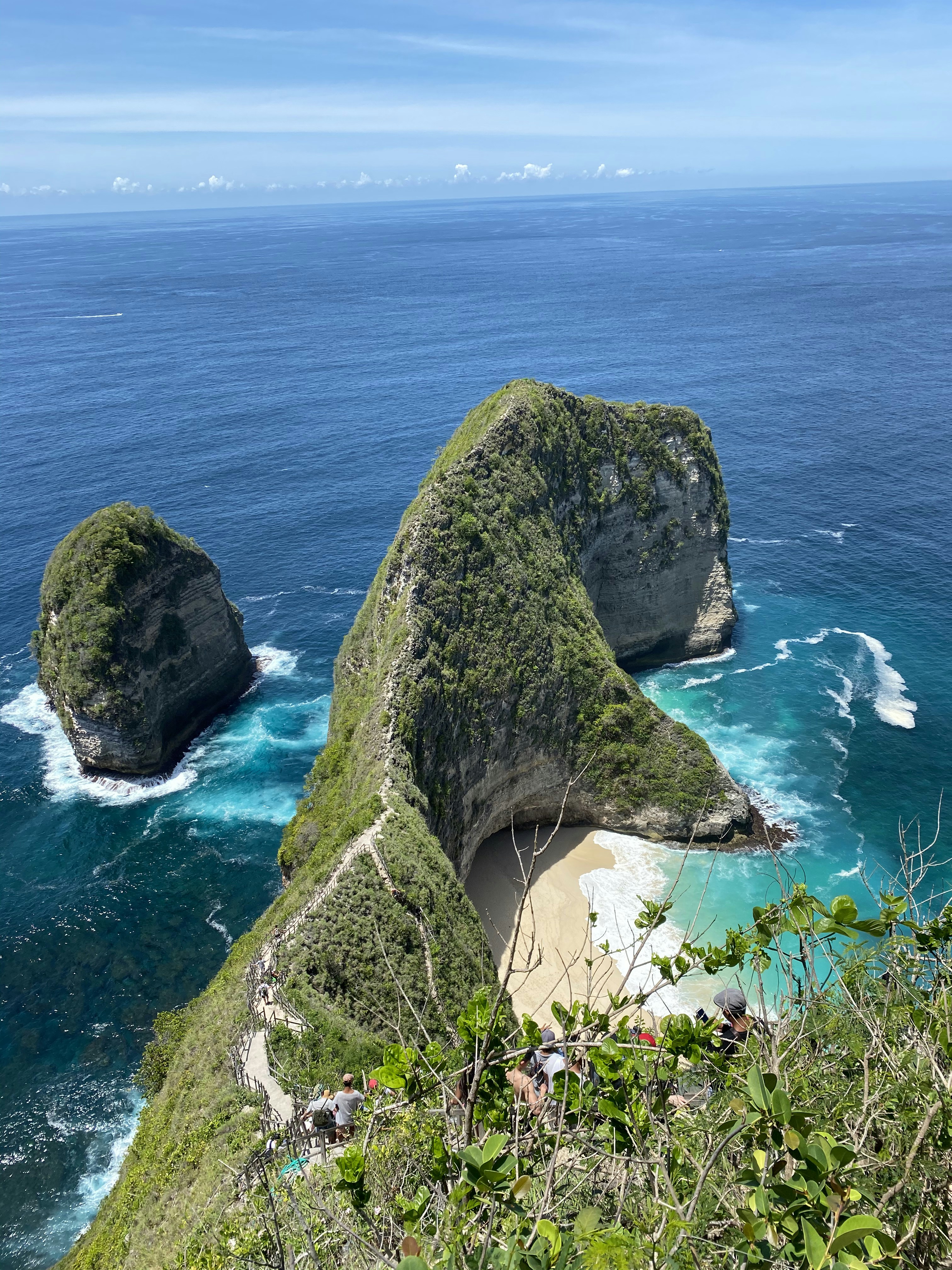 green and brown rock formation on sea during daytime