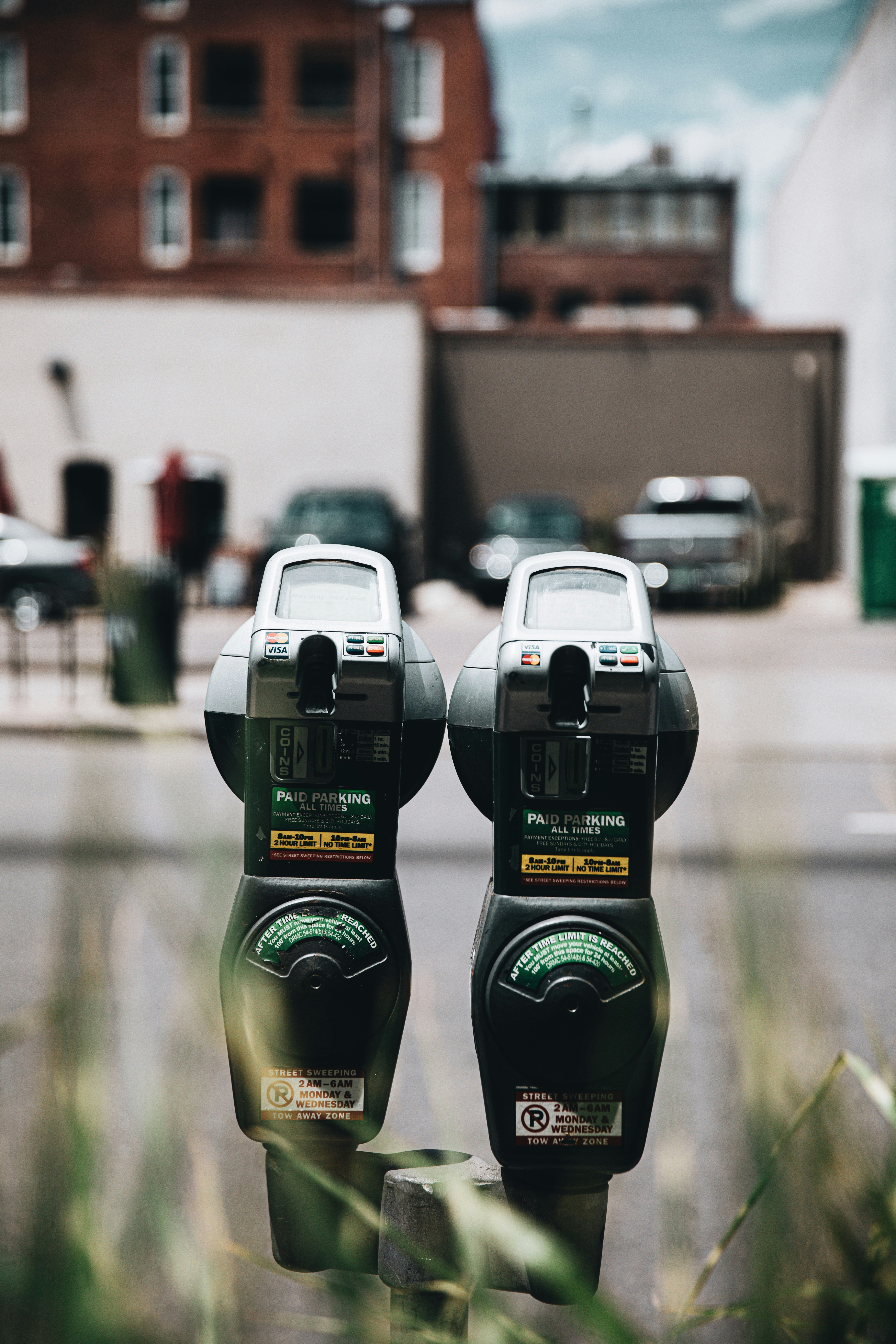 2 green and black parking meter