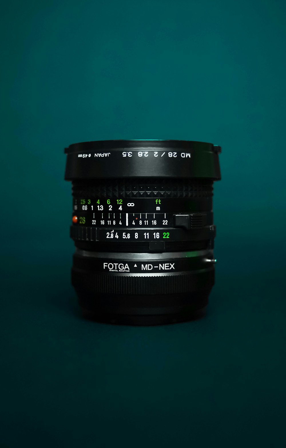 black camera lens on green surface