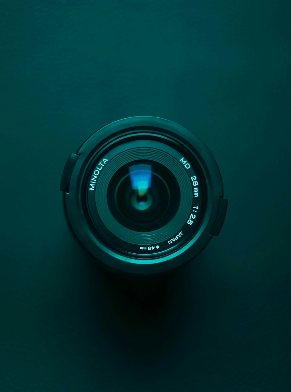 black camera lens on blue surface