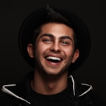 man in black and white nike zip up jacket smiling