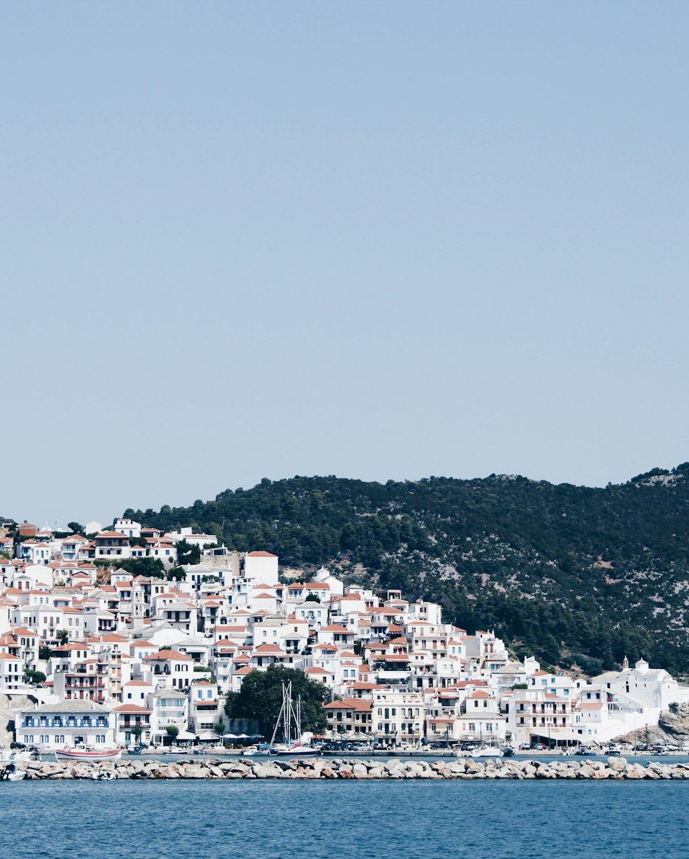 white and brown concrete buildings near mountain during daytime