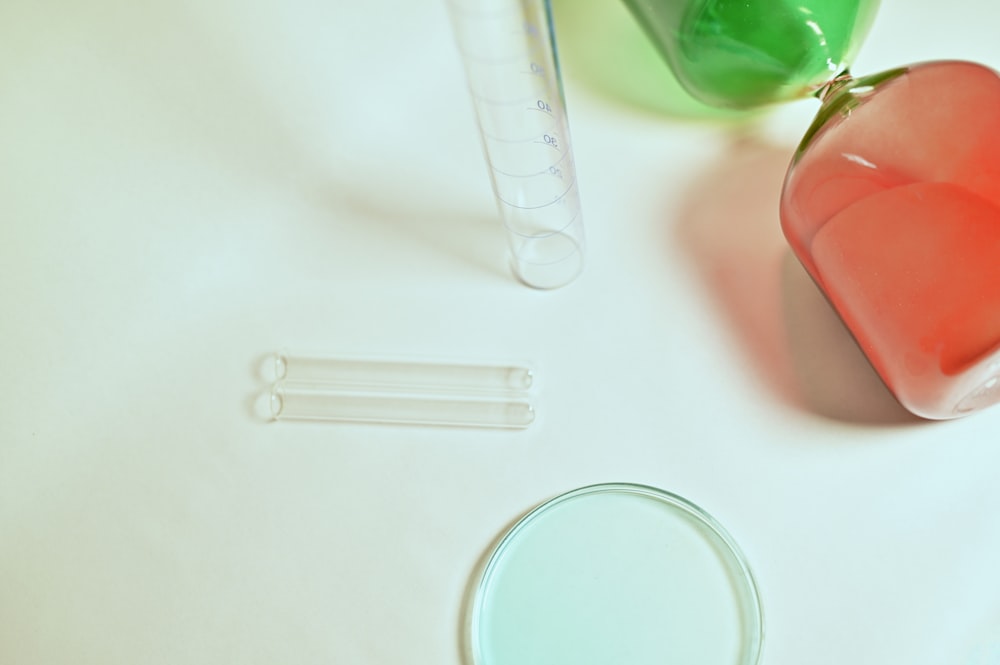 clear plastic measuring cup on white table