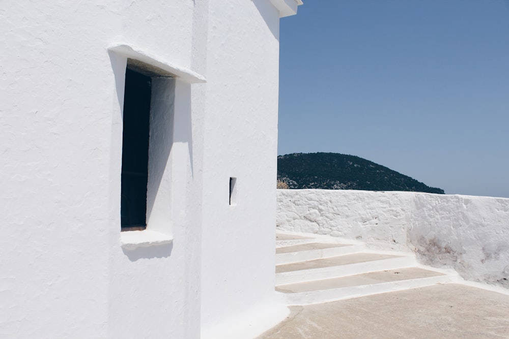 white concrete building on white sand during daytime