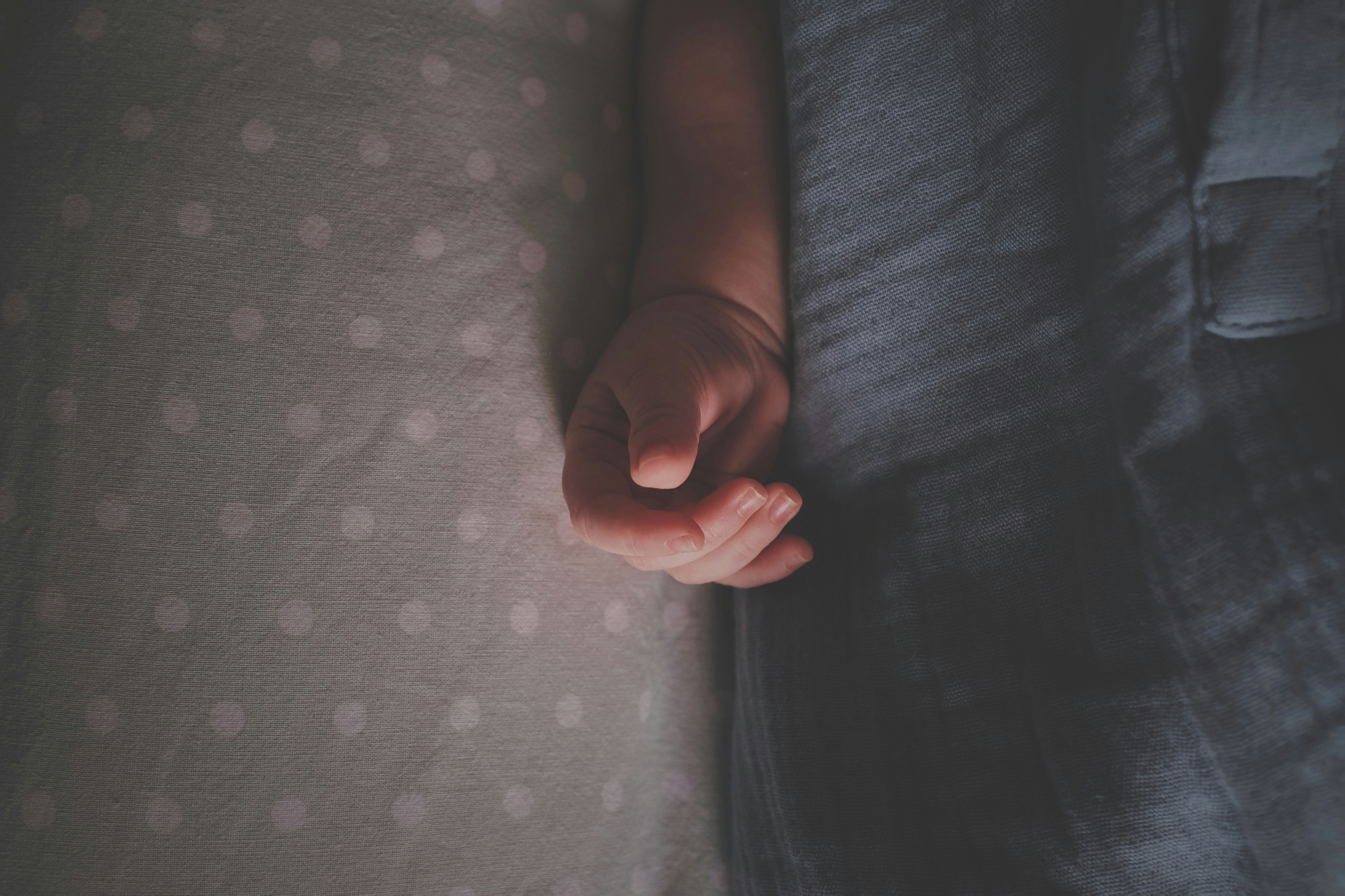 persons feet on white and pink polka dot textile