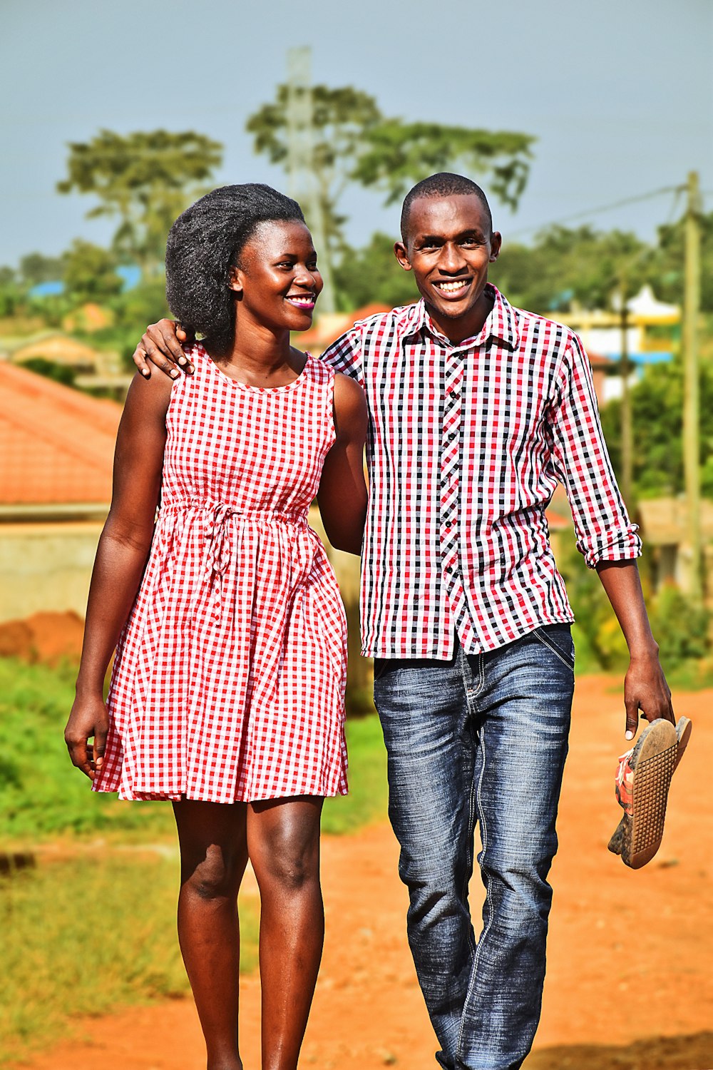 man and woman holding hands while walking during daytime