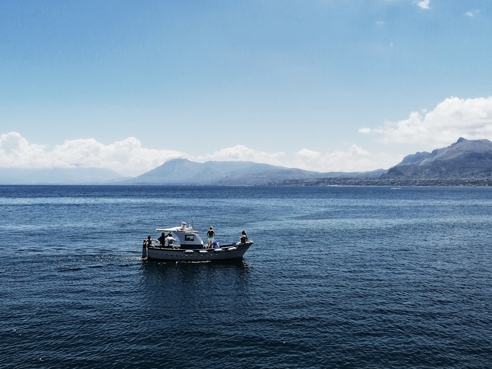 white and black boat on sea during daytime