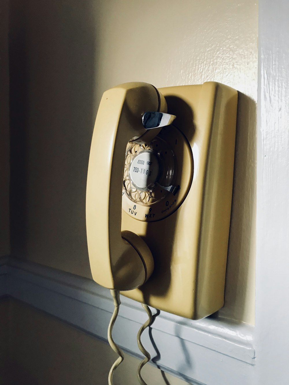 beige and black rotary phone