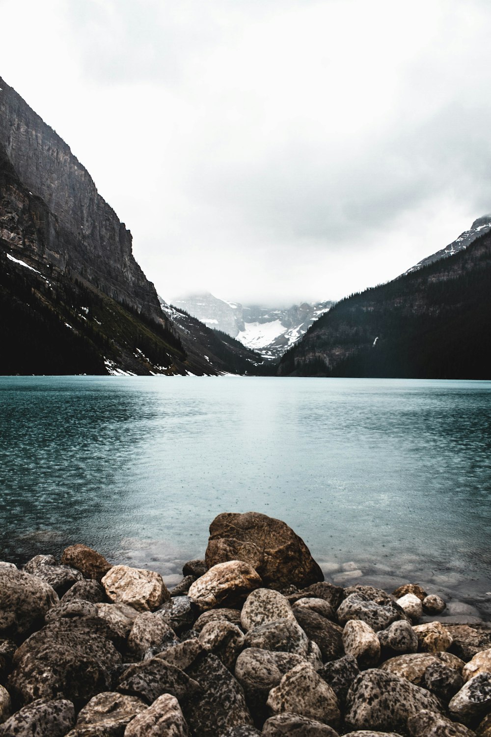 rocky shore with mountains in the distance