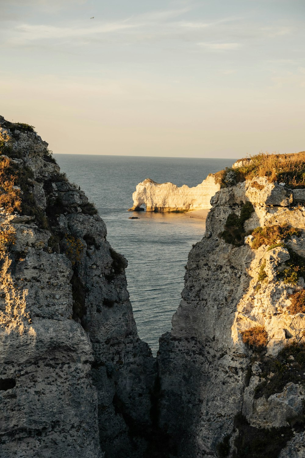 brown rock formation near body of water during daytime