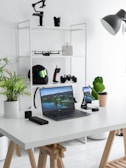 black laptop computer on white table
