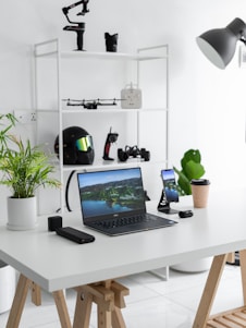 black laptop computer on white table