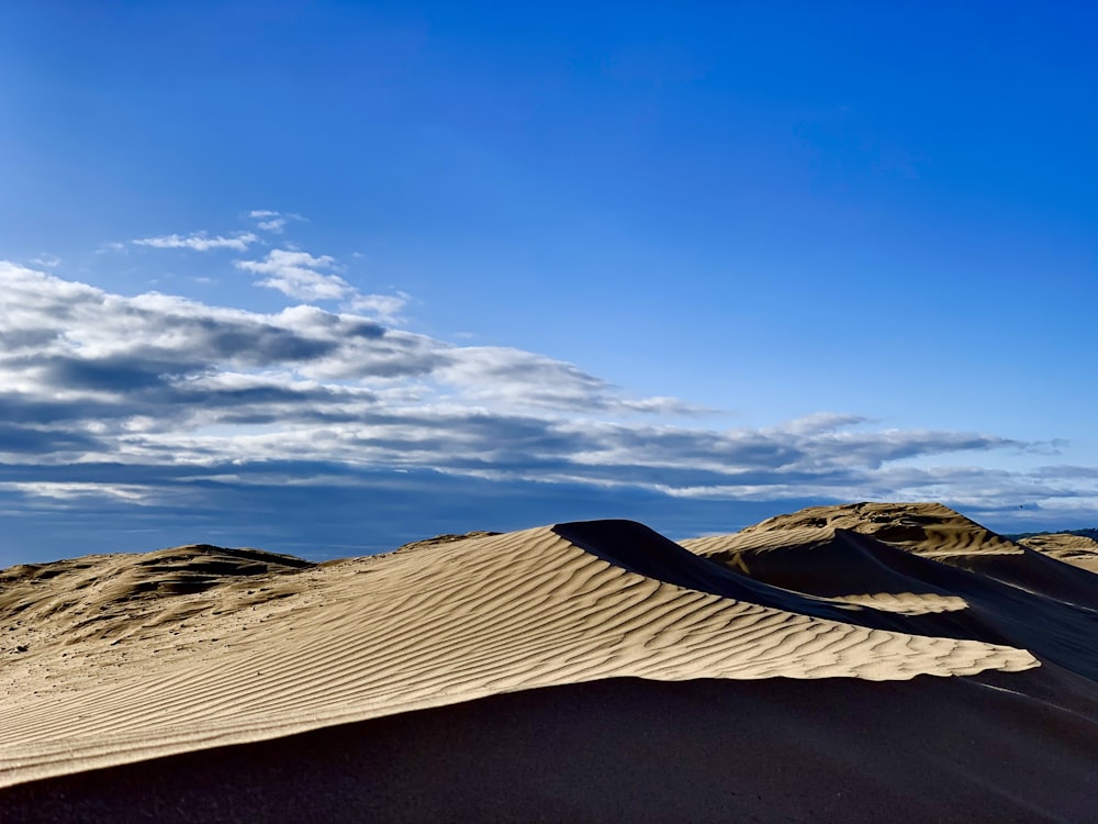 brown sand under blue sky during daytime