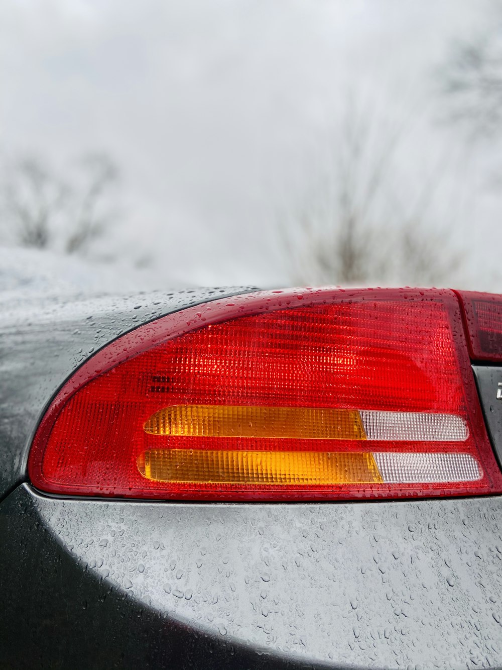 red car on snow covered road during daytime