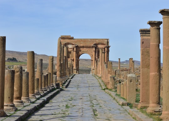 brown concrete arch under blue sky during daytime in Batna Algeria