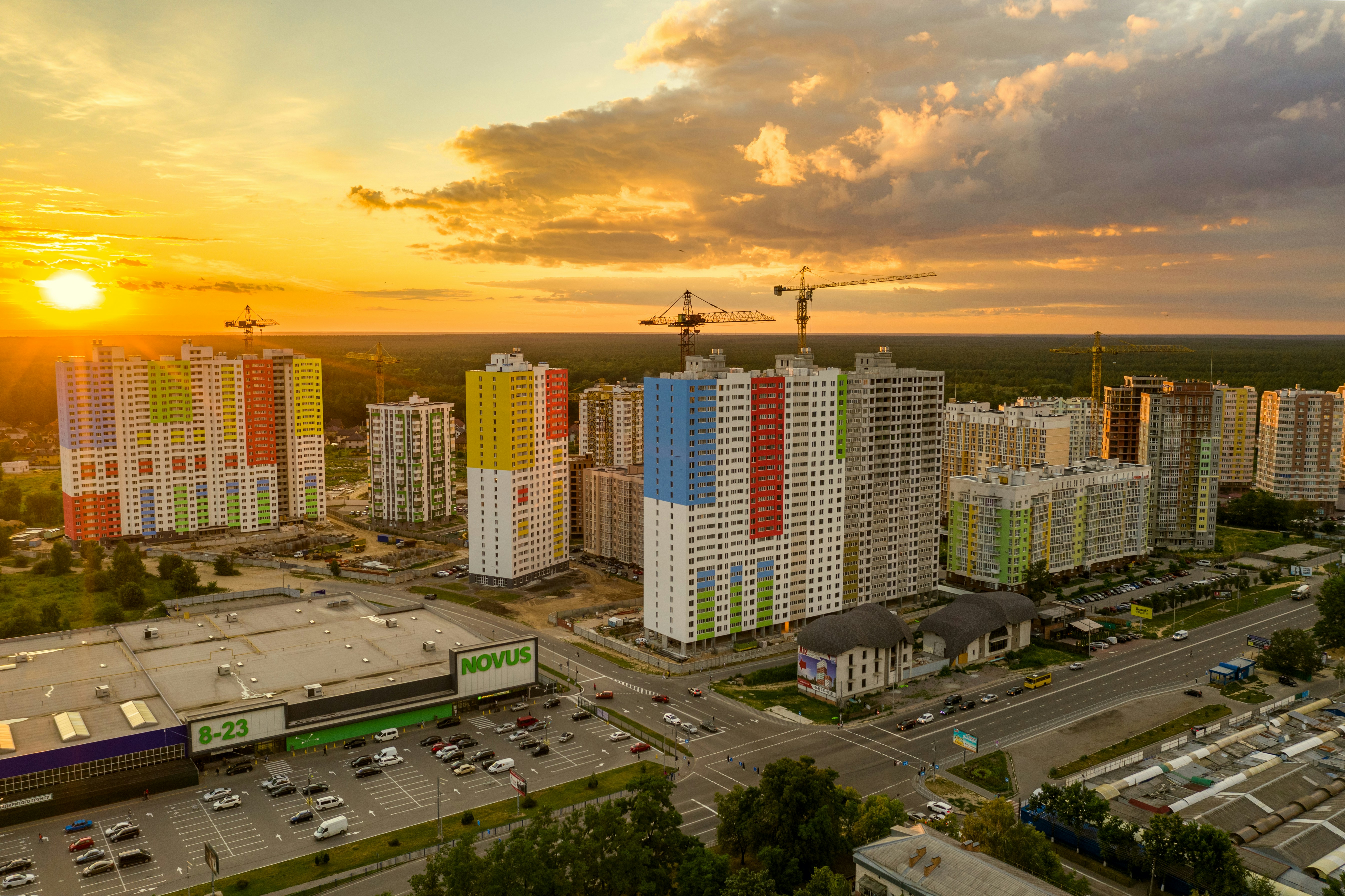 city buildings under orange and gray cloudy sky during sunset