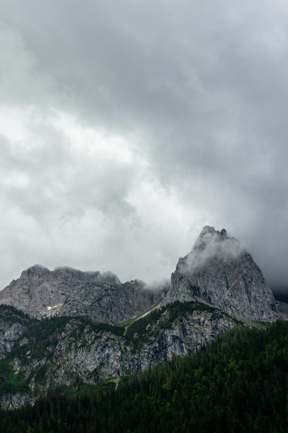 green and gray mountain under white clouds