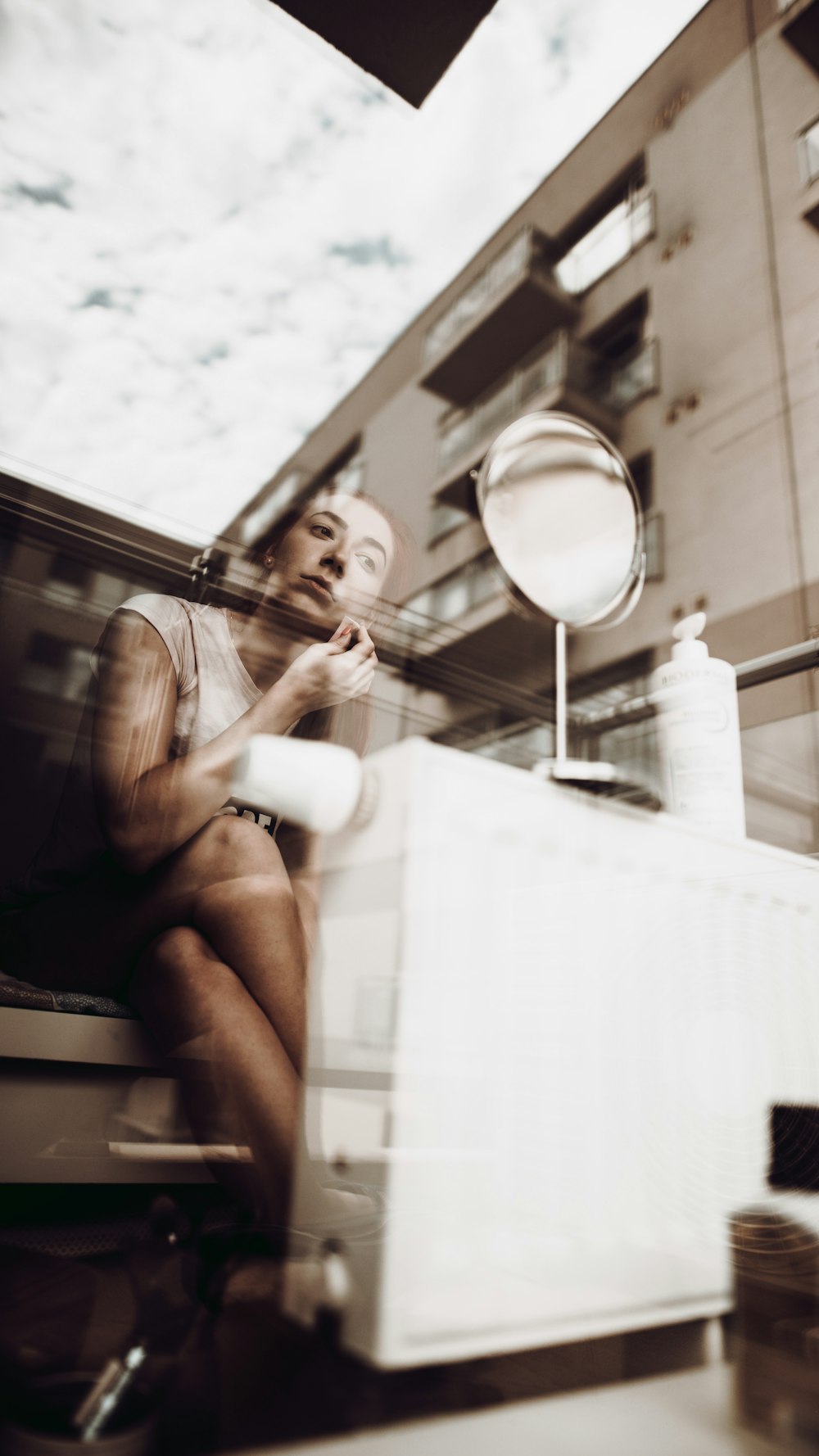 woman in white t-shirt and black shorts sitting on white chair