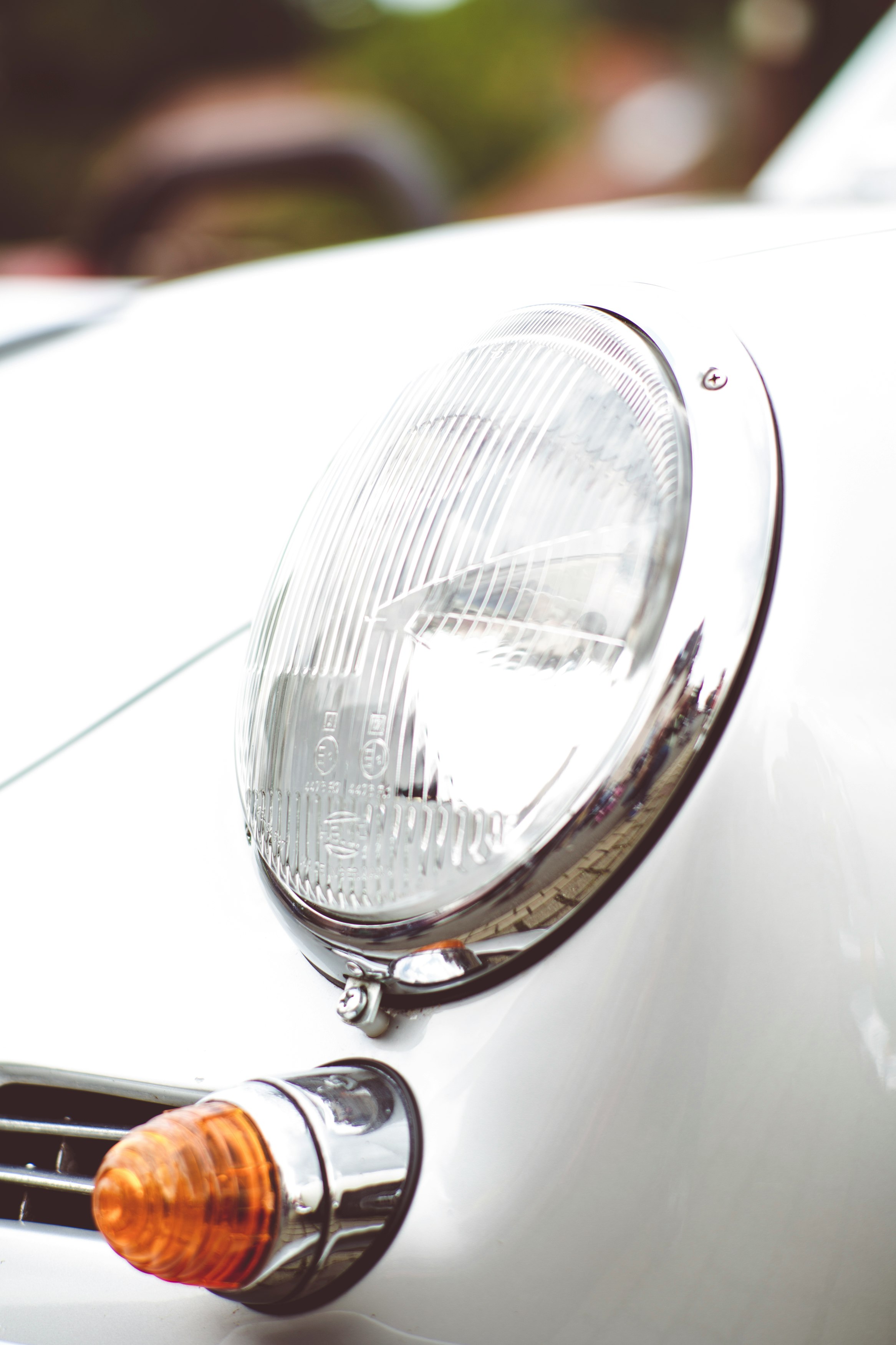 silver car headlight in close up photography