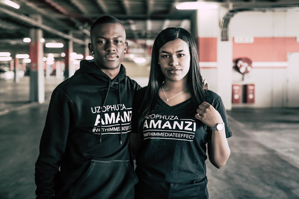 man in black hoodie standing beside woman in black hoodie