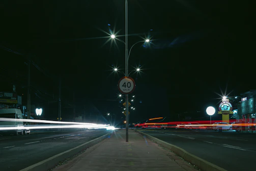 Close-up of a reflective street sign showing speed limits during dusk.