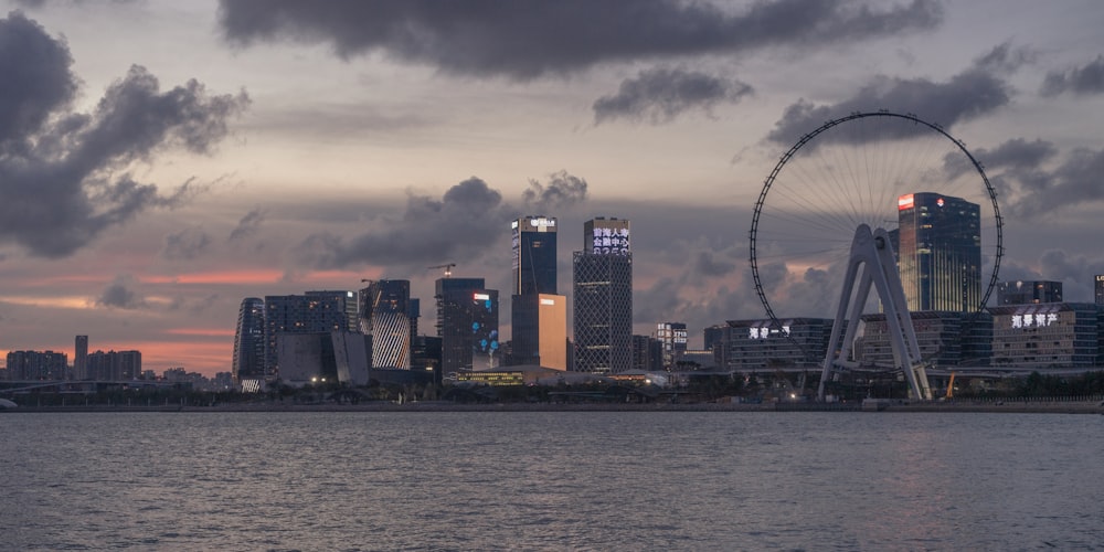 city skyline across body of water during sunset