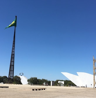 white and green flag on brown field under blue sky during daytime